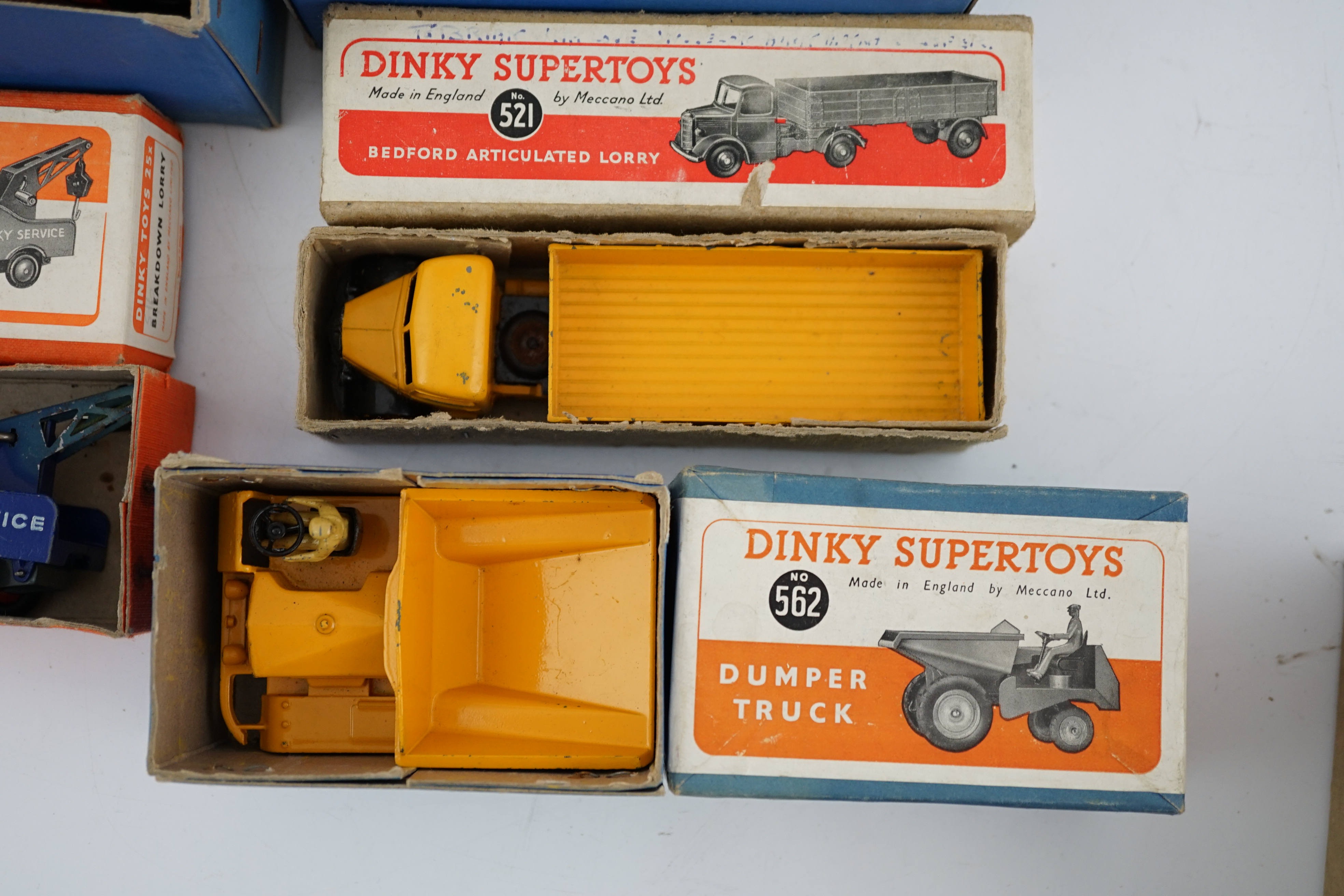 Five boxed Dinky Supertoys and Dinky Toys; a Breakdown Lorry (25x) dark grey with dark blue back, a Bedford Articulated Lorry (521) in yellow, a Blaw Knox Bulldozer (561) In red with green rubber tracks, a Dumper Truck (